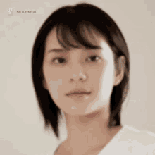 a close up of a woman 's face with short hair .