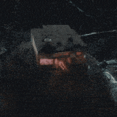 a dark room with a small building on top that says n