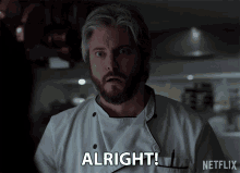 a man in a chef 's uniform is saying alright