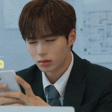 a man in a suit and tie is looking at his phone with a speech bubble that says ' ? ' on it