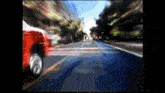 a blurry picture of a red car driving down a highway