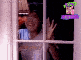 a woman looks out a window with a sticker that says 80 90 fantastica