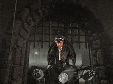 a man in a helmet is holding a gun in a dark room