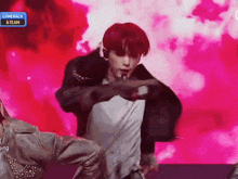 a man with red hair is dancing in front of a pink background that says comeback & team on it