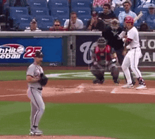 a baseball game is being played in front of a sign that says 25th hit baseball
