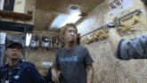 a man wearing a hurley t-shirt is standing in a room