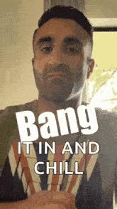 a man wearing a shirt that says bang it in and chill on it