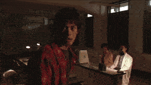 a man in a red jacket is surrounded by a white glow