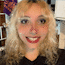 a close up of a woman 's face with a red spot on her nose