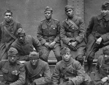 a group of soldiers are posing for a photo and one of them has a medal on his arm