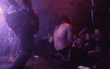 a blurry image of a crowd of people watching a performer on stage