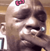 a man with a hello kitty bow on his forehead