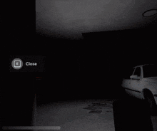 a white car is parked in a dark garage
