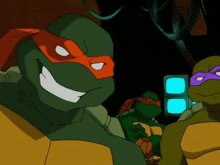 a group of teenage mutant ninja turtles are smiling
