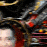 a blurry picture of a man 's face with an x on the bottom left