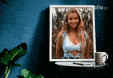 a picture of a woman in a bikini is hanging on a blue wall