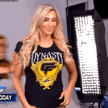 a woman is wearing a black shirt that says dynasty on it .
