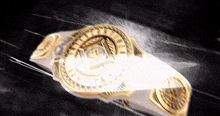 a gold belt is flying through the air with a black background .