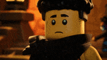 a close up of a lego man with a sad face