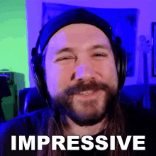 a man with long hair and a beard wearing headphones and a hat says impressive