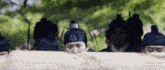 a group of men wearing traditional korean hats are standing in a row .