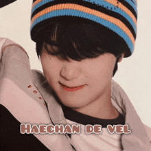 a picture of haechan de vel with a striped hat on