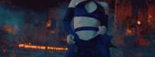 a woman in a blue top and black pants is dancing in a dark room .