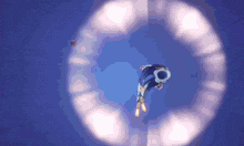 a person is flying through a circle with a blue background