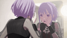a girl with purple hair looks at her reflection in a mirror