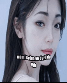 a close up of a woman 's face with the words mami keluarin dari kk