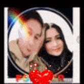 a blurry picture of a man and a woman with a red heart in the middle
