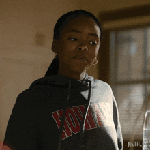 a woman wearing a hoodie that says netflix on the front