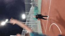 a person is playing basketball on a court with a sign that says ' allianz ' on it