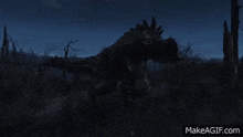 a giant monster is walking through a field at night .