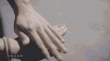 a man is putting a ring on a woman 's finger .
