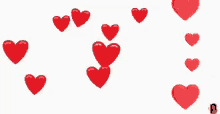 a bunch of red hearts are floating in the air .