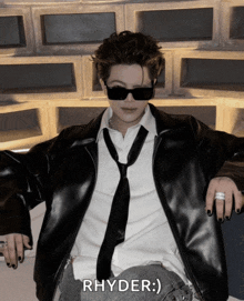 a man wearing sunglasses and a leather jacket with the name rhyder on it
