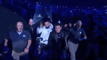 a man in a white jacket with ufc on it