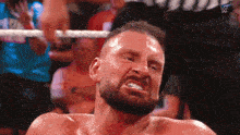 a man with a beard is making a funny face in a ring .