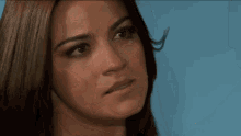 a woman is looking at a man with a sad look on her face