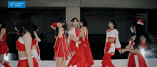 a group of girls are dancing in front of a sign that says " up front works "