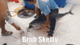 a man is holding a large fish that says bruh sketty