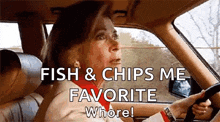 a woman is driving a car with the words `` fish and chips me favorite whore '' written on the screen .