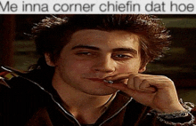 a man smoking a cigarette with a caption that says me inna corner chifin dat hoe