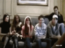 a group of people are sitting on a couch with rbd.gif written below them
