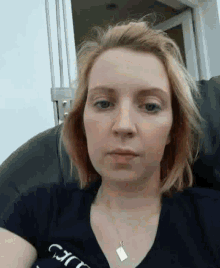 a woman wearing a black t-shirt that says gucci on it