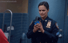 a woman in a police uniform is holding a cell phone and says ugh so much porn
