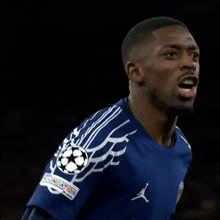 a soccer player wearing a blue jersey with the word jordan on the front