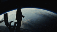 a man in a suit is standing in front of a globe