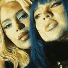 two women with blonde hair and blue hair are posing for a picture together